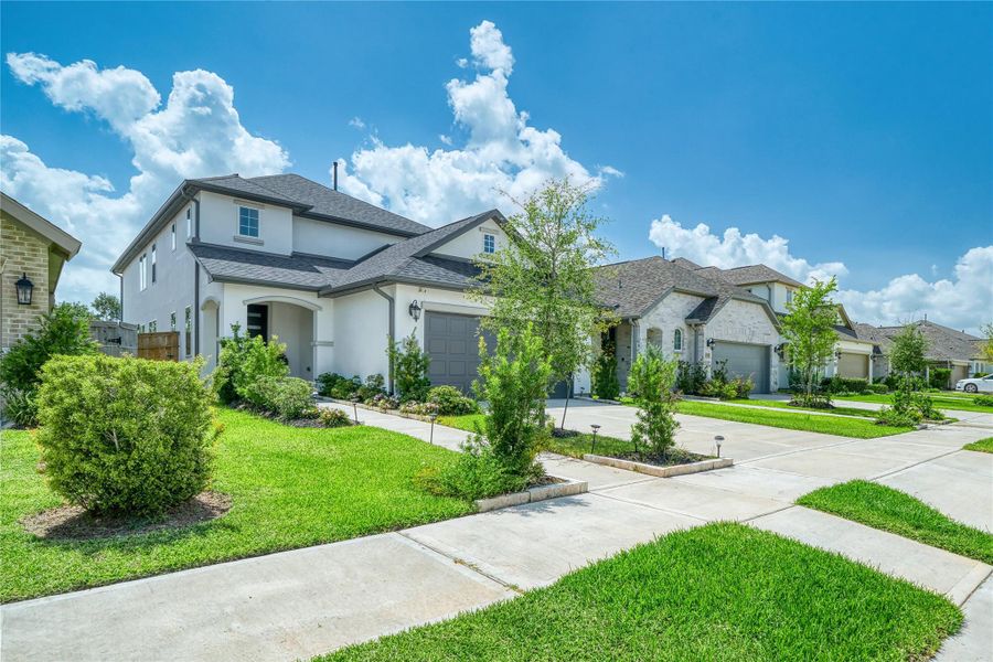 Front exterior of a new home in Sienna 40', Missouri City, TX, highlighting curb appeal (Image 1). Front exterior of a new home in Sienna 40', Missouri City, TX, highlighting curb appeal (Image 1).