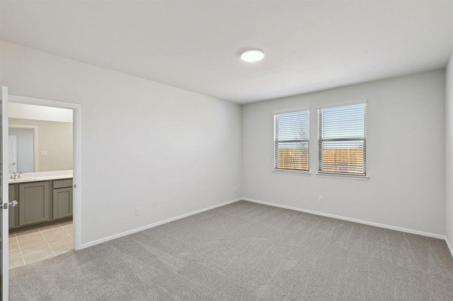 Primary Bedroom in the Holden home plan by Trophy Signature Homes – REPRESENTATIVE PHOTO