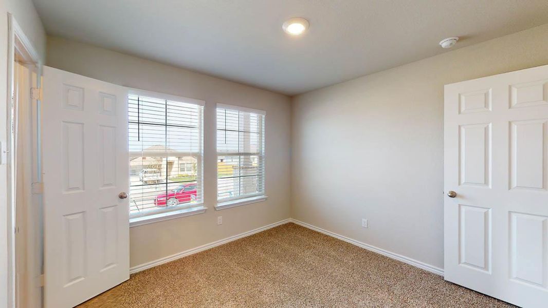 Unfurnished bedroom featuring baseboards and light carpet