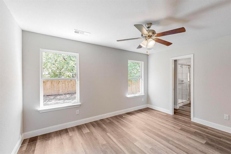 Spare room with ceiling fan, light hardwood / wood-style flooring, and a healthy amount of sunlight