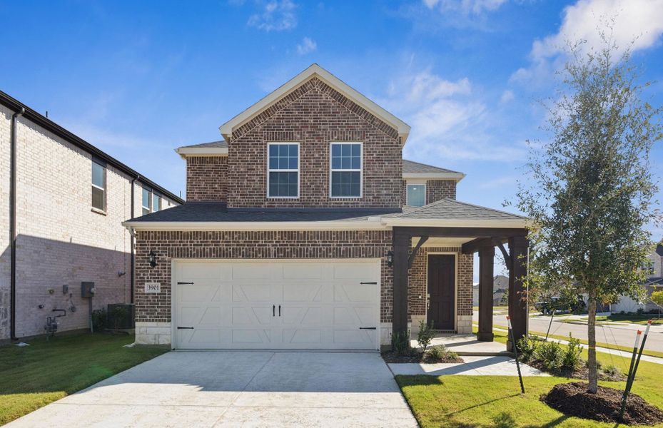 Front exterior of a new home in Spiritas Ranch, Little Elm, TX, highlighting curb appeal (Image 1). Front exterior of a new home in Spiritas Ranch, Little Elm, TX, highlighting curb appeal (Image 1).