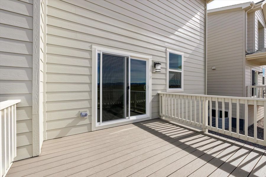 A porch with a white railing. A porch with a white railing.