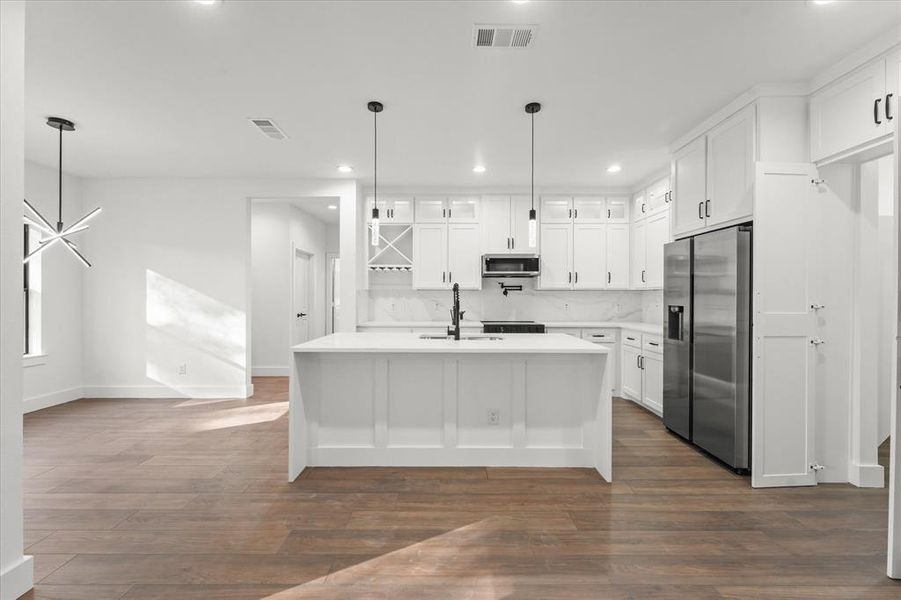 Kitchen with white cabinetry, sink, dark wood-type flooring, and appliances with stainless steel finishes