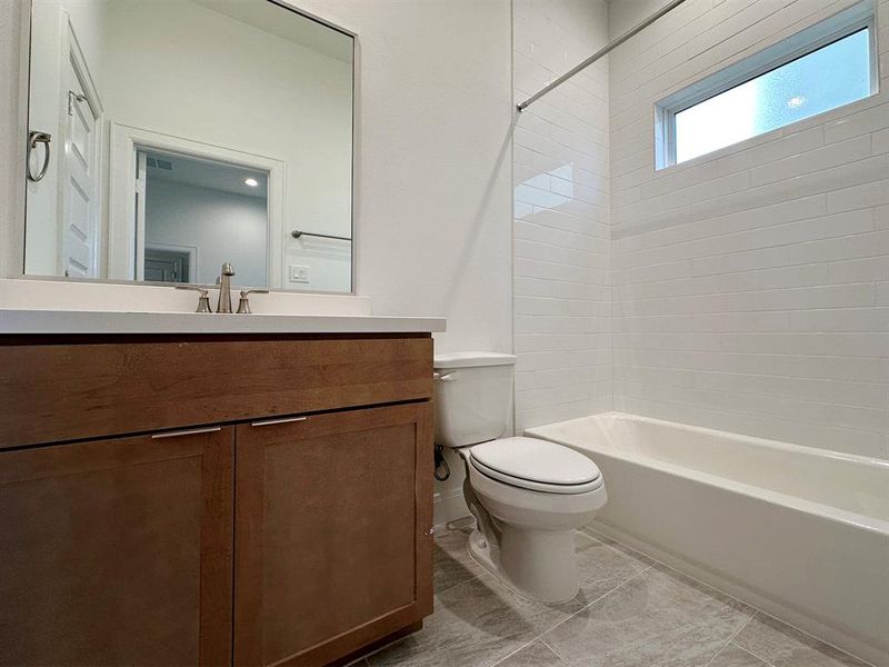 1st Floor - Bathroom #3 with tub/shower combo. *Photos of previous model with similar floor plan.  Finishes will be based on spec for Erin Park community.*