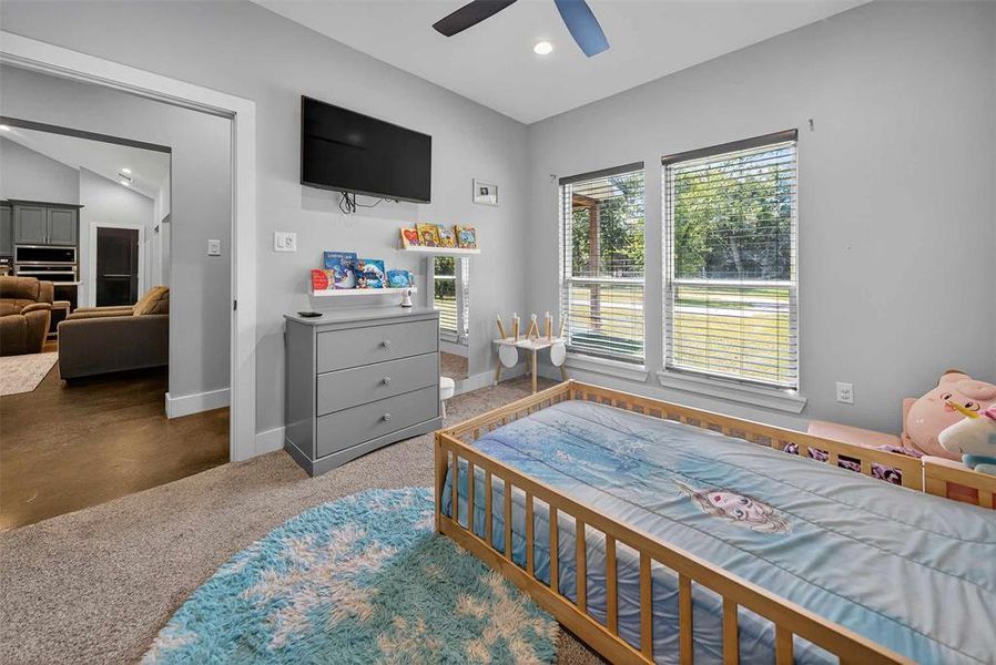 Bedroom featuring a ceiling fan, recessed lighting, and finished concrete flooring Bedroom featuring a ceiling fan, recessed lighting, and finished concrete flooring