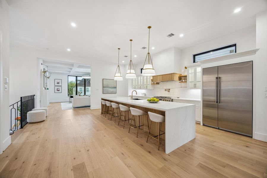 Great, open expansive space.  Large Island with Breakfast Bar Seating for Six and Acoustic Slat Wood Panel Front.  Coordinating Wood Panel Front also on the Hood.