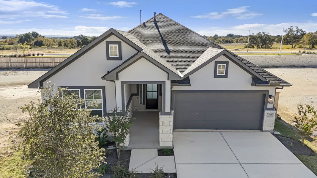 Front exterior of a new home in The Grove at Blackhawk, Pflugerville, TX, highlighting curb appeal (Image 31). Front exterior of a new home in The Grove at Blackhawk, Pflugerville, TX, highlighting curb appeal (Image 31).
