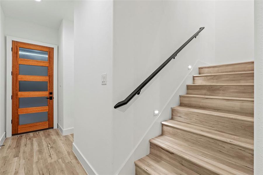 Stairs with hardwood / wood-style flooring