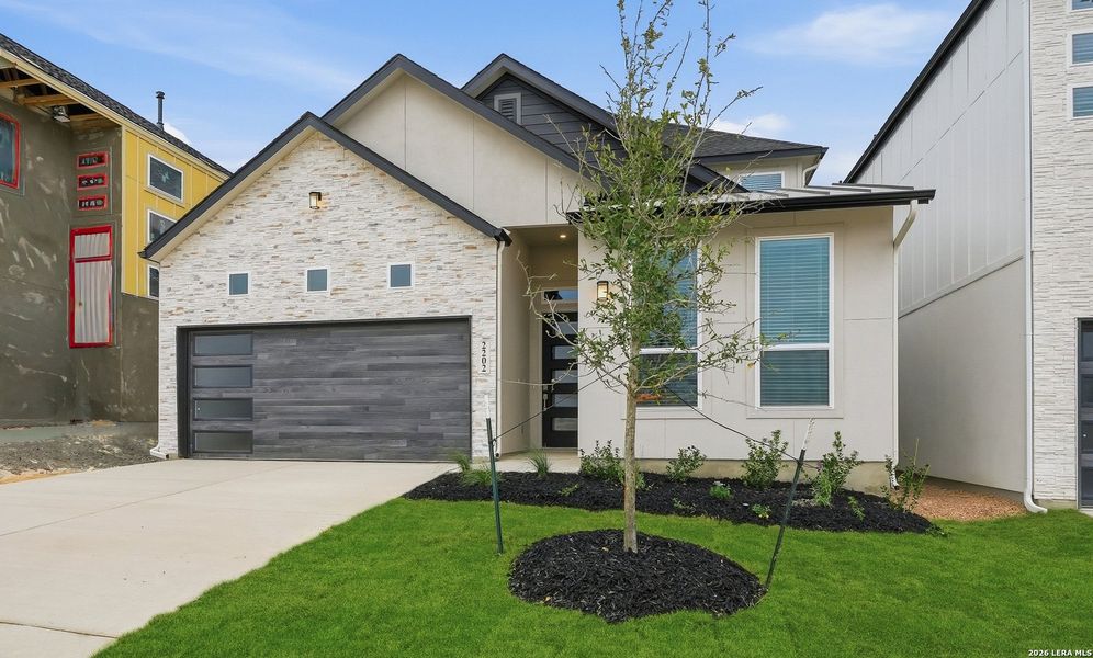 Front exterior of a new home in Prominence, San Antonio, TX, highlighting curb appeal (Image 22).