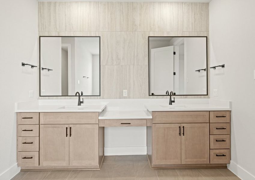 The master bathroom has a dual-sink vanity with a makeup station in between.