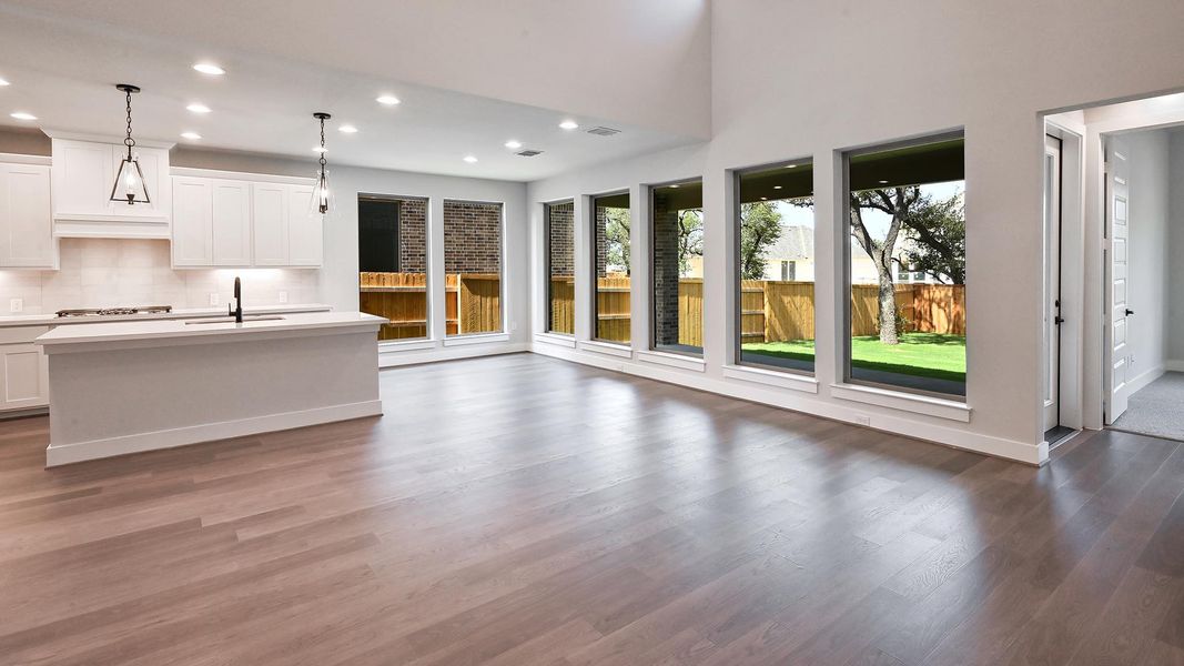 Kitchen with recessed lighting, dark wood-style flooring, light countertops, open floor plan, and backsplash