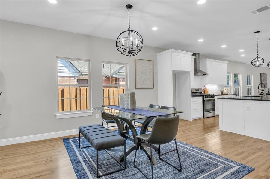 Dining area featuring a chandelier, recessed lighting, and light wood-style floors