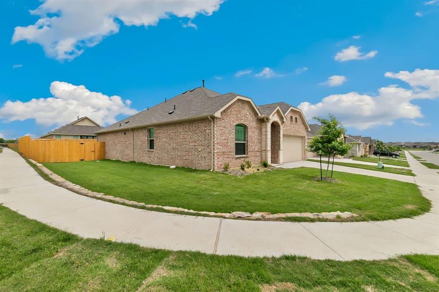 View of front of home with a front lawn and a garage