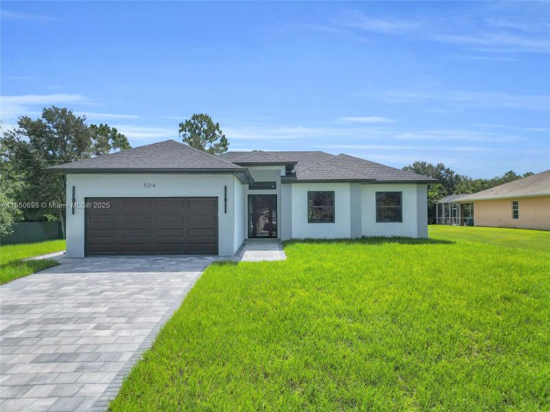Front exterior of a new home in , Lehigh Acres, FL, highlighting curb appeal (Image 17). Front exterior of a new home in , Lehigh Acres, FL, highlighting curb appeal (Image 17).