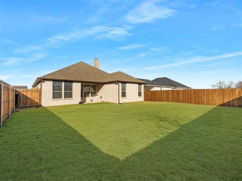 Back of house featuring a lawn