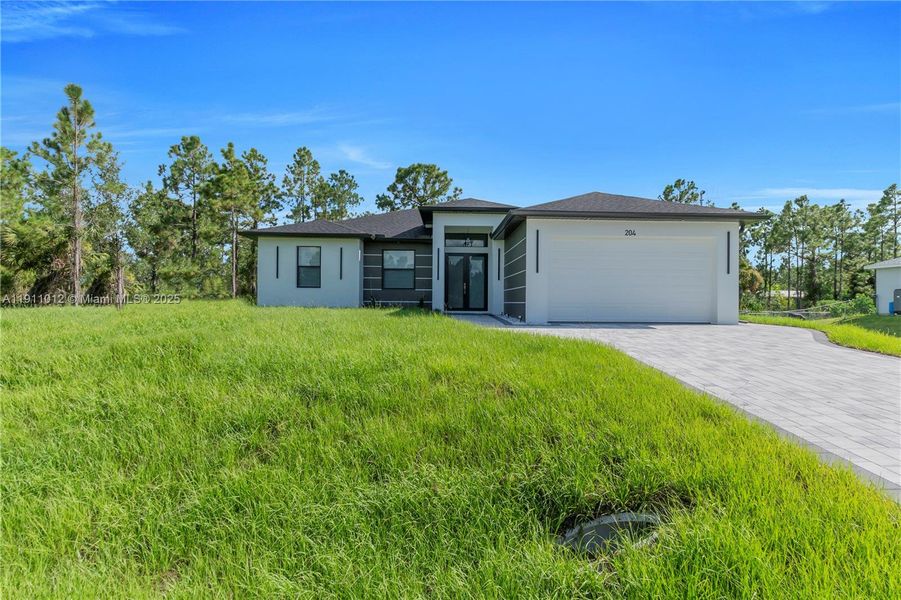 Front exterior of a new home in , Lehigh Acres, FL, highlighting curb appeal (Image 2). Front exterior of a new home in , Lehigh Acres, FL, highlighting curb appeal (Image 2).
