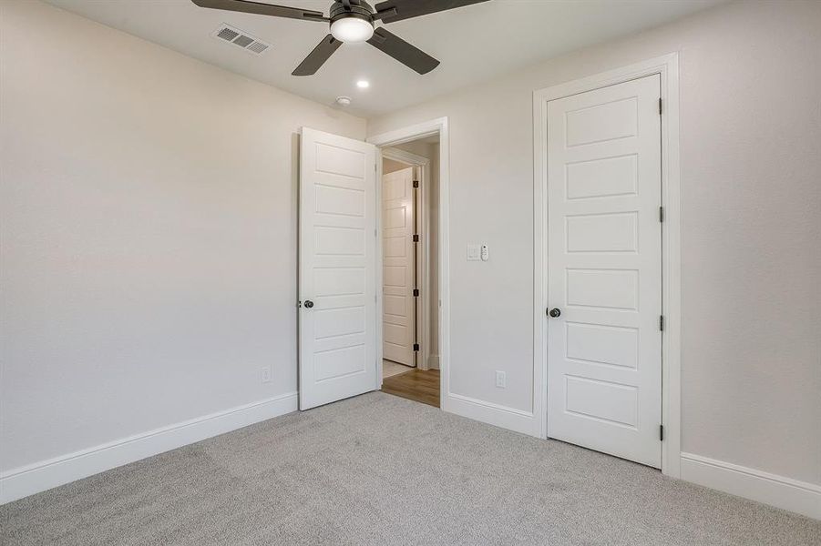 BEDROOM 2 offers a ceiling fan, carpet, and nice sized closet.