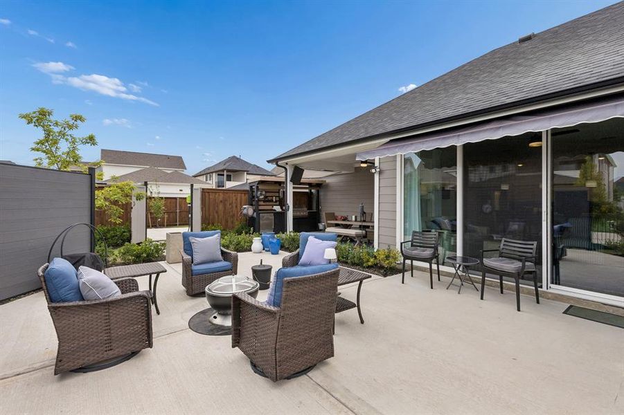 The expansive outdoor living design blends covered and open-air spaces, creating multiple areas for relaxing, entertaining, and enjoying the outdoors.