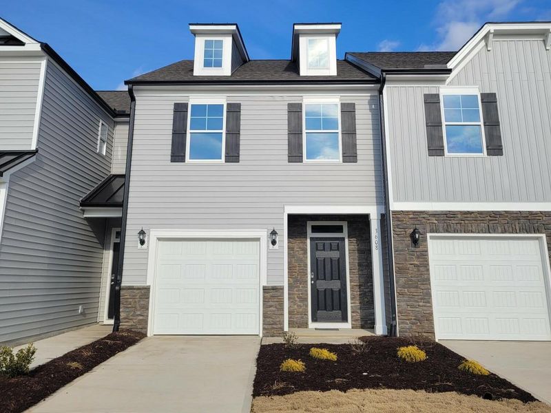 Front exterior of a new home in 1158 Place Townhomes, Wilson, NC, highlighting curb appeal (Image 1).