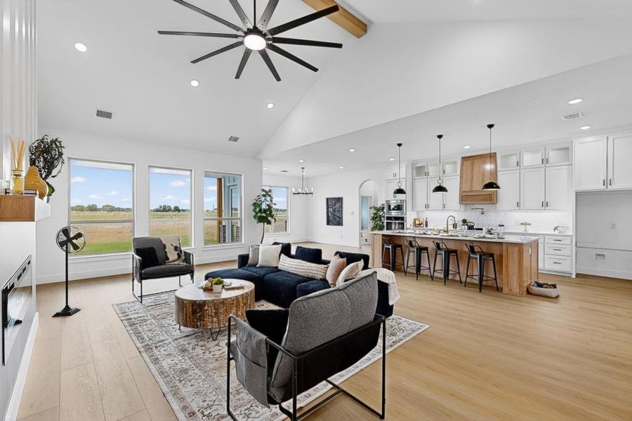 Living room with beam ceiling, recessed lighting, light wood-style floors, high vaulted ceiling, and a ceiling fan