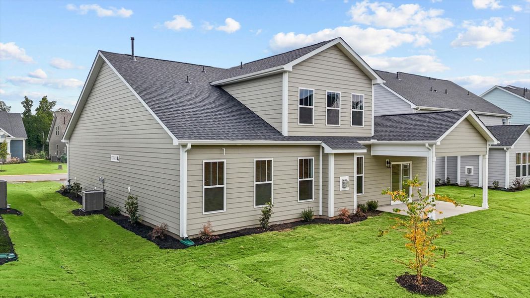 Rear covered porch creates a seamless extension of this home’s elegant design