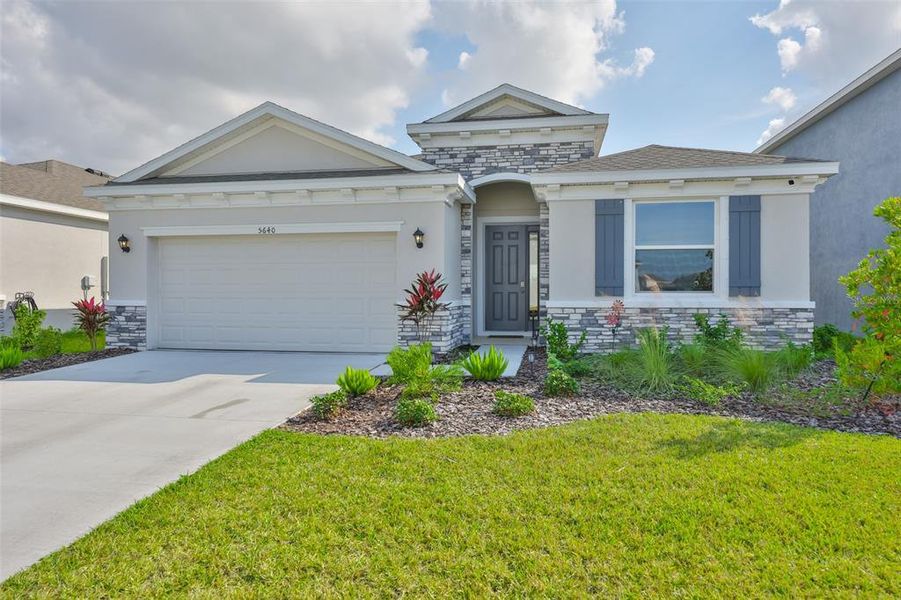 Front exterior of a new home in Silverstone North, Palmetto, FL, highlighting curb appeal (Image 22).