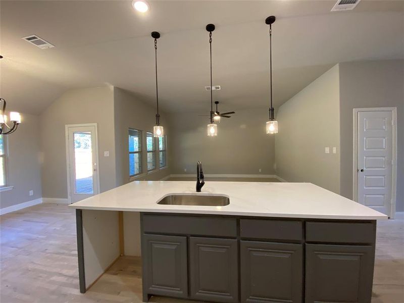 View from massive kitchen island towards famile room & cafe (stainless GE dishwasher not installed yet) View from massive kitchen island towards famile room & cafe (stainless GE dishwasher not installed yet)