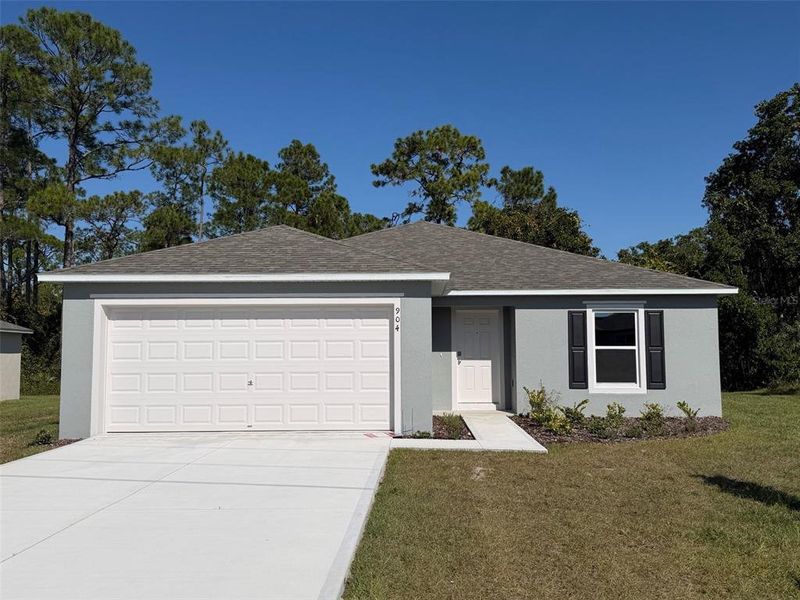 Front exterior of a new home in , Poinciana, FL, highlighting curb appeal (Image 1). Front exterior of a new home in , Poinciana, FL, highlighting curb appeal (Image 1).