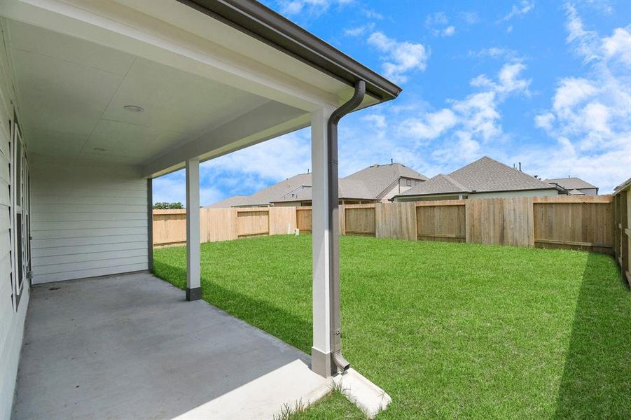 Experience outdoor living at its finest on this expansive covered patio, thoughtfully designed for BBQs and delightful outdoor dining. Sample photo of completed home with similar floor plan. As-built interior colors and selections may vary.