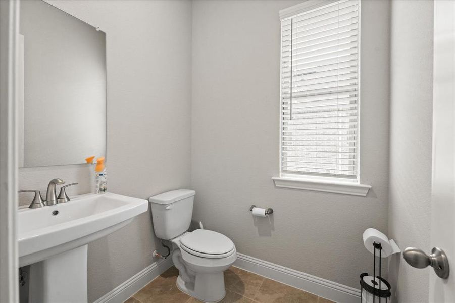 Bathroom with sink, toilet, and tile patterned floors