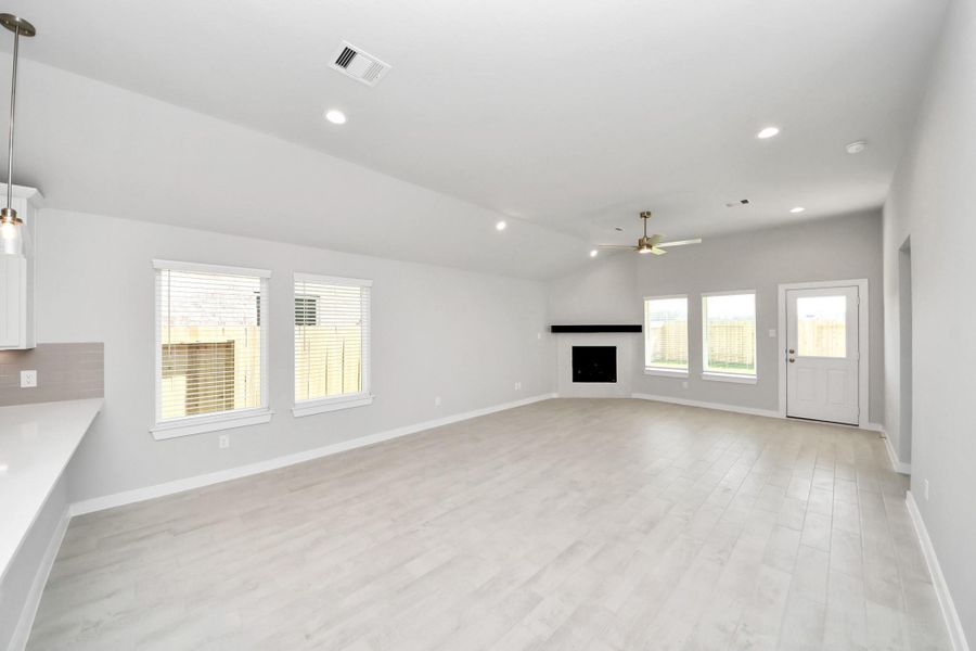 Family room flooded with natural light through the expansive windows. The premium tile flooring adds a touch of luxury to the space, creating the perfect setting for relaxing moments and cherished gatherings with loved ones. Sample photo of completed home with similar floor plan. Actual colors and selections may vary. Family room flooded with natural light through the expansive windows. The premium tile flooring adds a touch of luxury to the space, creating the perfect setting for relaxing moments and cherished gatherings with loved ones. Sample photo of completed home with similar floor plan. Actual colors and selections may vary.