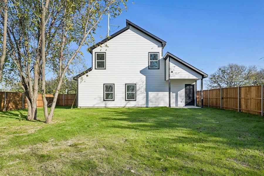 Back of property with a fenced backyard and a patio area