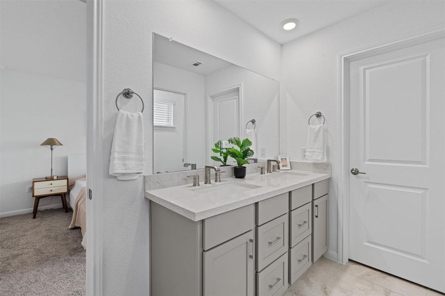 Primary bathroom features a walk-in shower and dual vanity