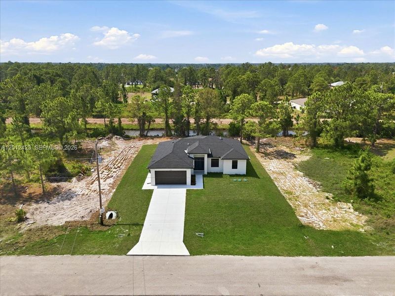 Front exterior of a new home in , Lehigh Acres, FL, highlighting curb appeal (Image 23).