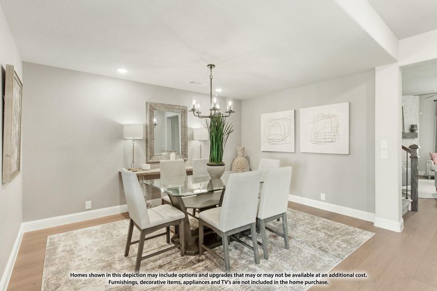 Dining room with glass-top table, six upholstered chairs, chandelier, and hardwood floors