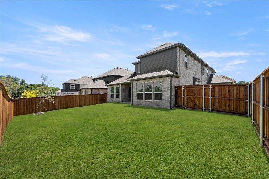 Front exterior of a new home in Spiritas Ranch, Little Elm, TX, highlighting curb appeal (Image 25).