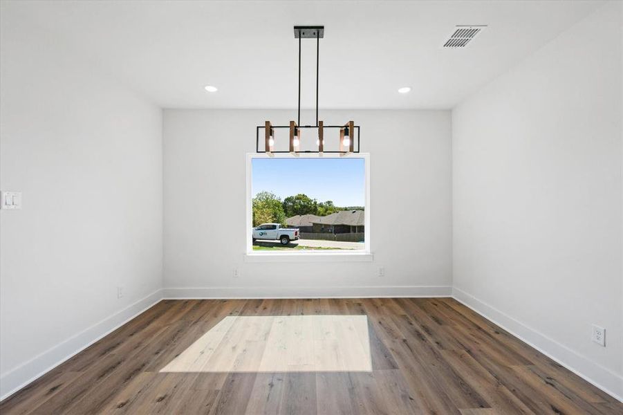 Unfurnished dining area with a modern light fixture