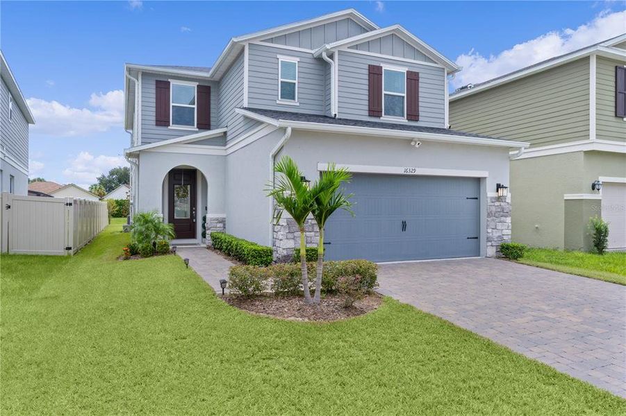 Front exterior of a new home in , Clermont, FL, highlighting curb appeal (Image 20).