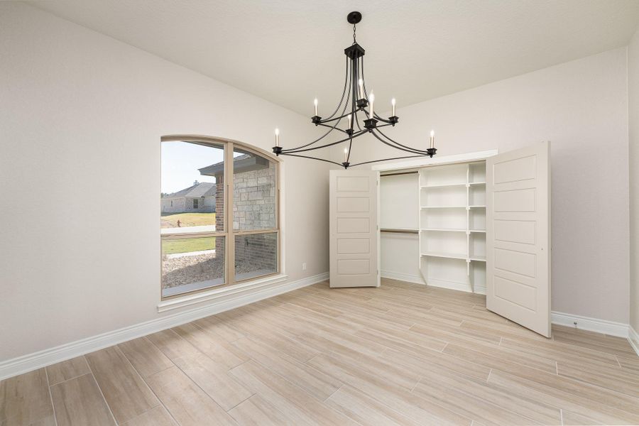 Unfurnished dining area with wood finish floors and a chandelier Unfurnished dining area with wood finish floors and a chandelier