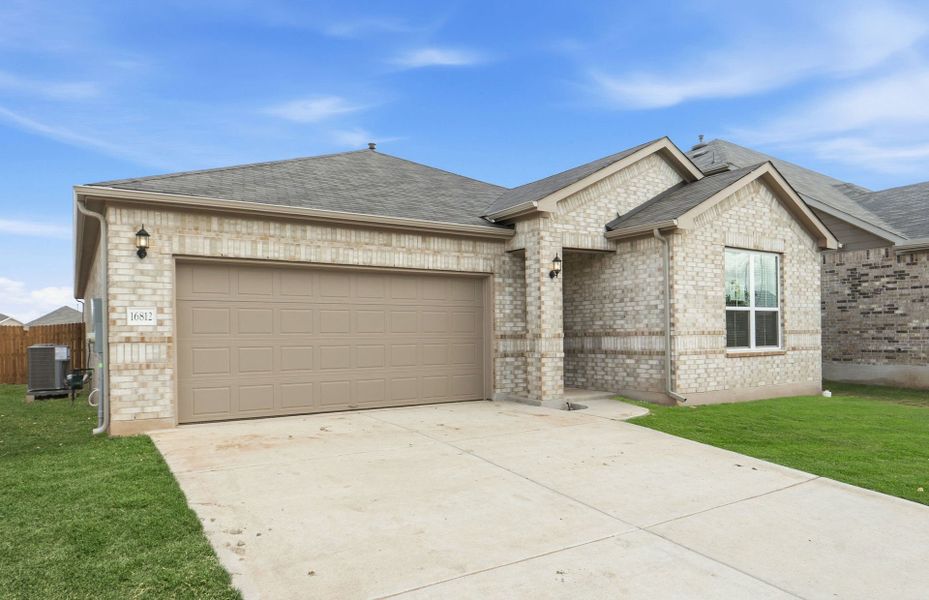 Front exterior of a new home in Lagos, Manor, TX, highlighting curb appeal (Image 22). Front exterior of a new home in Lagos, Manor, TX, highlighting curb appeal (Image 22).