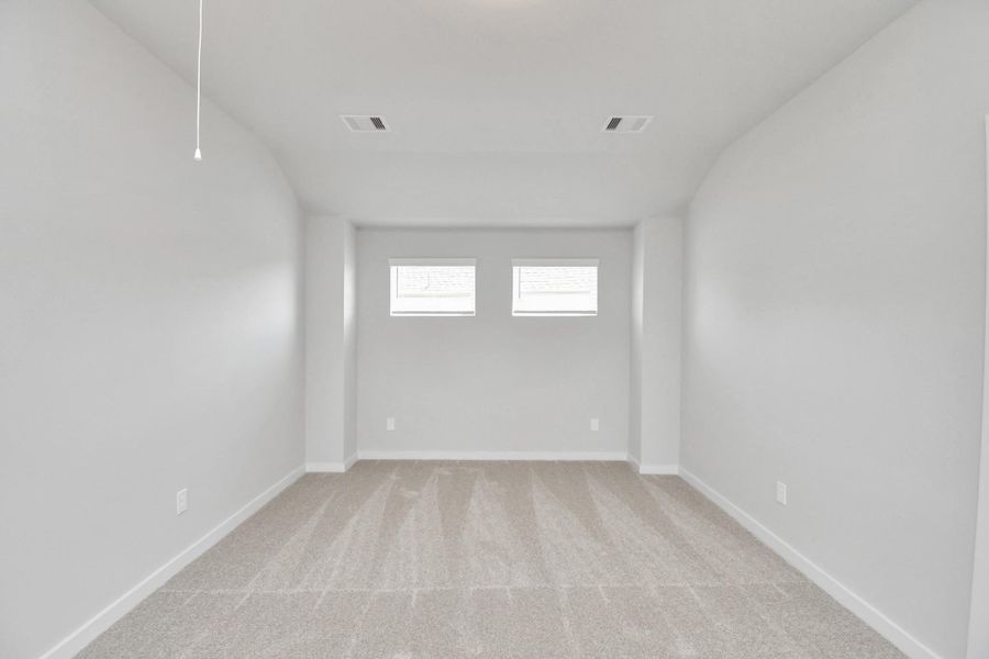 Come upstairs and relish a day of relaxation in this loft area! Ideal as an additional living space or game room, it boasts plush carpeting, high ceilings, custom paint, and windows that flood the area with abundant natural light. Come upstairs and relish a day of relaxation in this loft area! Ideal as an additional living space or game room, it boasts plush carpeting, high ceilings, custom paint, and windows that flood the area with abundant natural light.