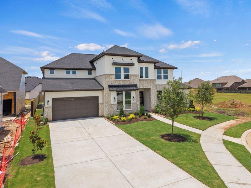 Front exterior of a new home in Harvest Green, Richmond, TX, highlighting curb appeal (Image 1). Front exterior of a new home in Harvest Green, Richmond, TX, highlighting curb appeal (Image 1).