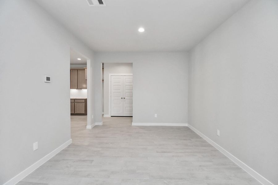 Create lasting memories with your family and friends at the dining table! This expansive dining room showcases sophisticated flooring, custom paint, and seamlessly connects to the family room and kitchen, providing an open and inviting atmosphere. Sample photo of completed home with similar floor plan. Actual colors and selections may vary. Create lasting memories with your family and friends at the dining table! This expansive dining room showcases sophisticated flooring, custom paint, and seamlessly connects to the family room and kitchen, providing an open and inviting atmosphere. Sample photo of completed home with similar floor plan. Actual colors and selections may vary.