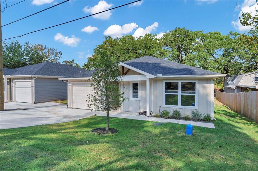 Ranch-style house with roof with shingles, board and batten siding, a garage, and concrete driveway Ranch-style house with roof with shingles, board and batten siding, a garage, and concrete driveway