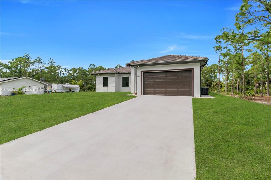 Front exterior of a new home in , Lehigh Acres, FL, highlighting curb appeal (Image 25). Front exterior of a new home in , Lehigh Acres, FL, highlighting curb appeal (Image 25).