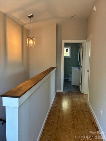 Stairwell, lots of natural light plus  modern fixtures. Wood floors, and Sherwin williams paint.