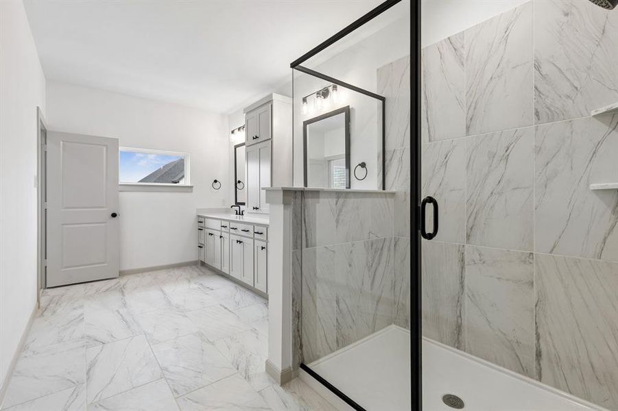 A spacious, walk in shower is the cherry on top in this beautiful Owner's bath.