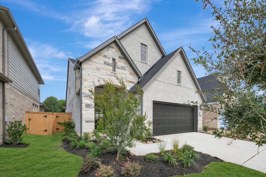 Front exterior of a new home in The Grand Prairie - Meadow Collection, Hockley, TX, highlighting curb appeal (Image 26). Front exterior of a new home in The Grand Prairie - Meadow Collection, Hockley, TX, highlighting curb appeal (Image 26).