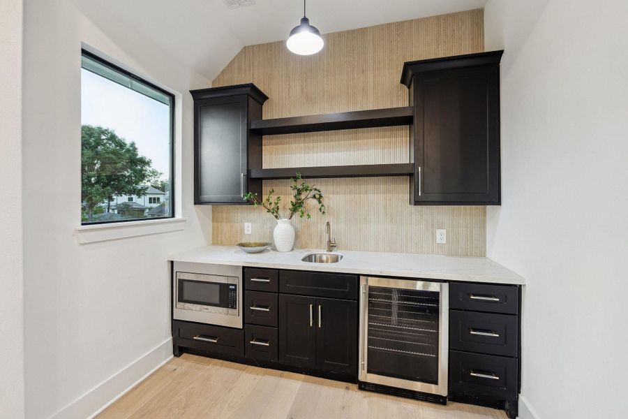 Convenient and stylish! Wet bar w drink fridge and microwave in the game room! Convenient and stylish! Wet bar w drink fridge and microwave in the game room!