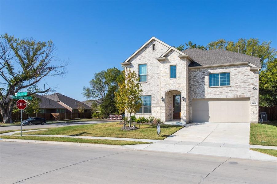 View of front of home featuring a garage and a front lawn